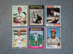 Vintage 1970s Topps baseball cards featuring Hall of Famers Tom Seaver, Joe Morgan, Al Kaline, Lou Brock, Phil Niekro, and Bob Gibson displayed on a grey surface